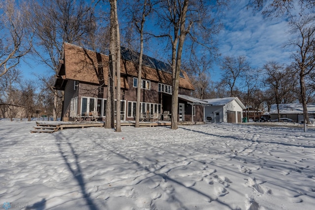 view of snow covered back of property