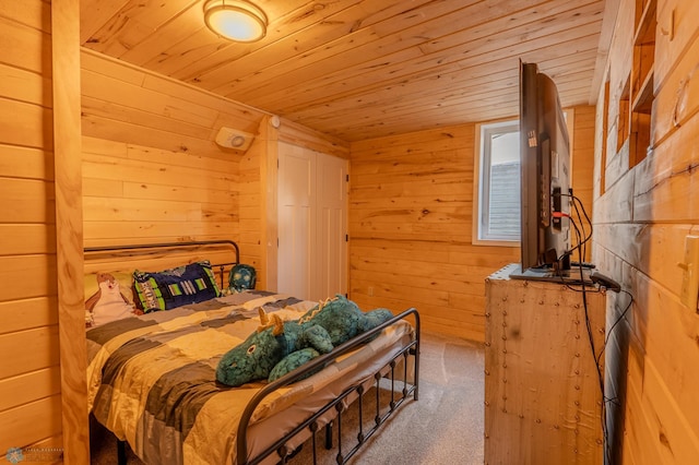 bedroom featuring carpet flooring, wood ceiling, and wooden walls