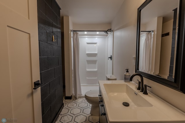 bathroom featuring vanity, a shower with shower curtain, tile patterned floors, and toilet