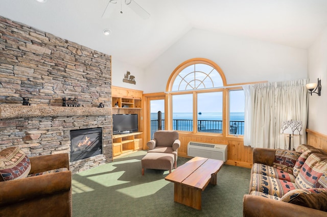 living room featuring vaulted ceiling, an AC wall unit, built in features, a fireplace, and dark colored carpet