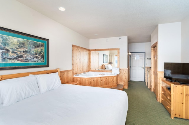 carpeted bedroom with wooden walls and a textured ceiling