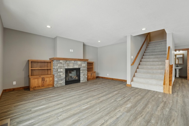 unfurnished living room featuring a fireplace and light wood-type flooring