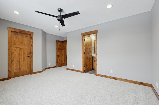 unfurnished bedroom with light carpet, ceiling fan, and ensuite bathroom