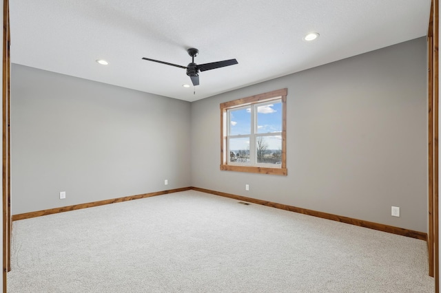 unfurnished room featuring ceiling fan and carpet flooring