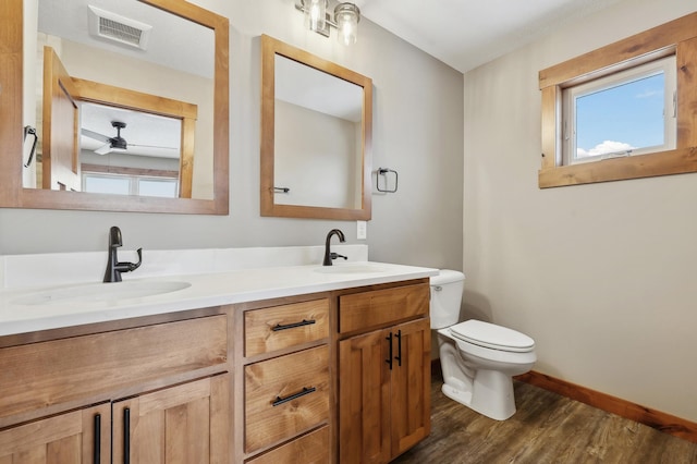 bathroom featuring vanity, wood-type flooring, and toilet