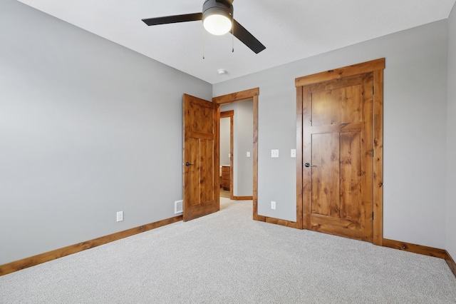 unfurnished bedroom with carpet floors, a closet, and ceiling fan