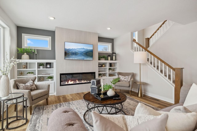 living room featuring hardwood / wood-style flooring and a fireplace