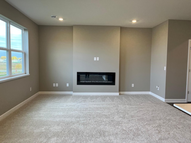 unfurnished living room featuring light colored carpet