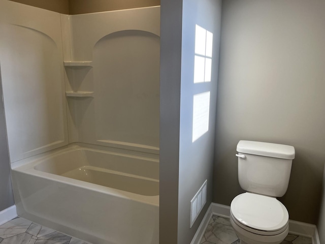 bathroom with toilet and a healthy amount of sunlight