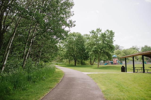 view of home's community featuring a lawn and a playground