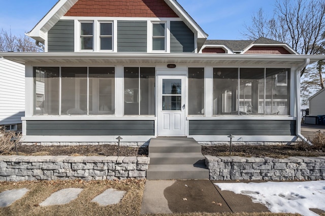 view of front of house featuring a sunroom