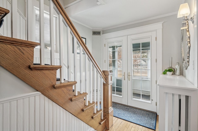 foyer with visible vents, wood finished floors, french doors, stairway, and crown molding