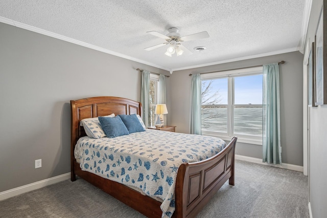 bedroom featuring a ceiling fan, baseboards, visible vents, crown molding, and carpet flooring