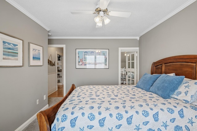 bedroom featuring a textured ceiling, crown molding, and baseboards