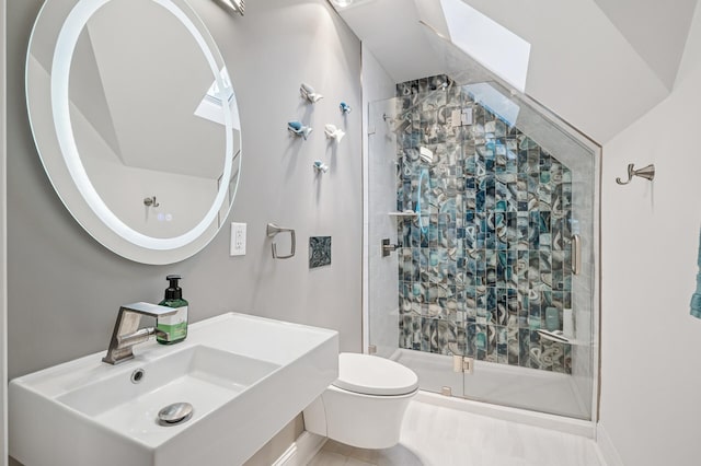 bathroom featuring a sink, toilet, and a shower stall