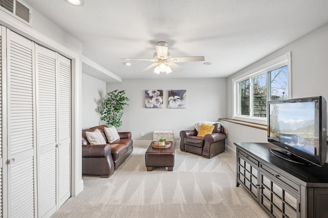 carpeted living room with visible vents, recessed lighting, and ceiling fan