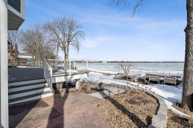 view of patio with a deck with water view