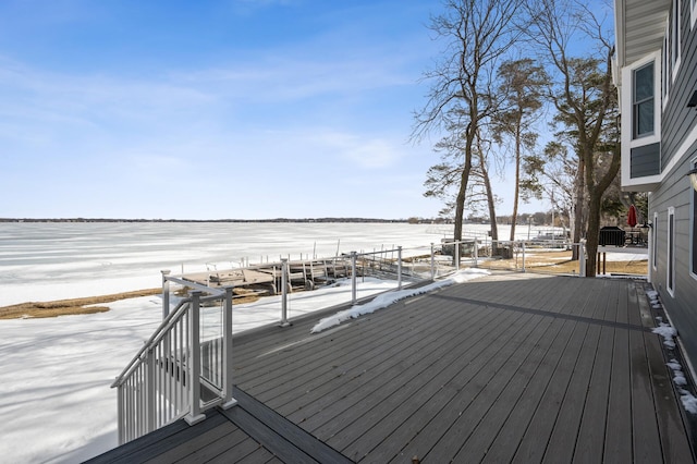 wooden terrace featuring a water view