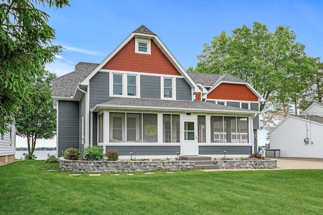 255 Shore Dr, Forest Lake, MN 55025 - view of front facade featuring a sunroom, a shingled roof, and a front yard