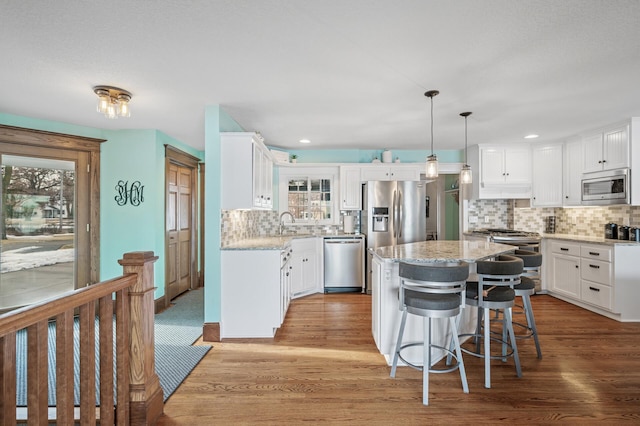 255 Shore Dr, Forest Lake, MN 55025 - kitchen featuring stainless steel appliances, tasteful backsplash, white cabinets, light wood-type flooring, and recessed lighting