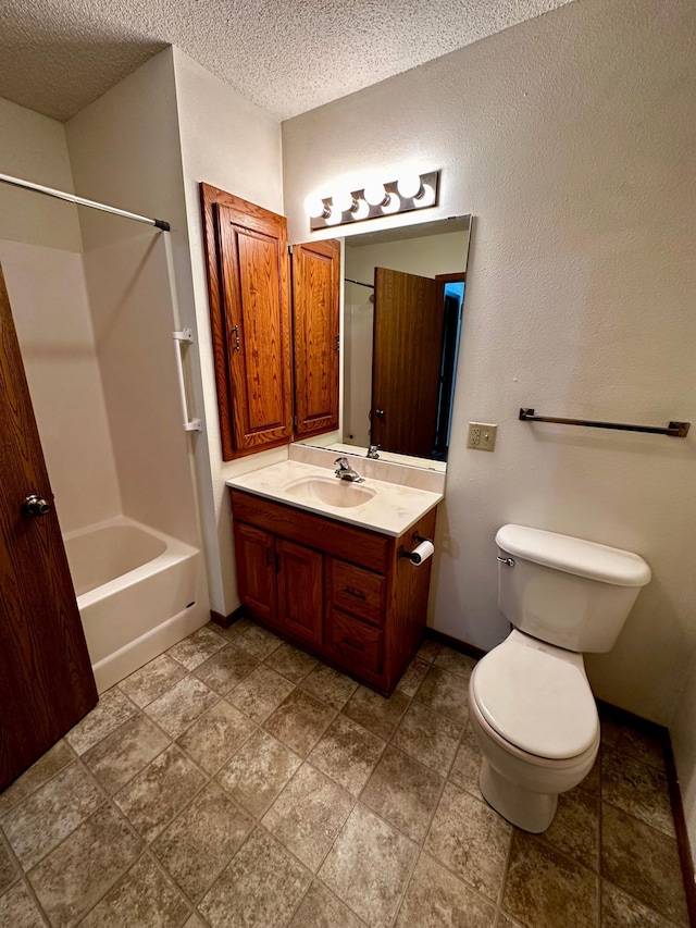 full bathroom with washtub / shower combination, vanity, toilet, and a textured ceiling