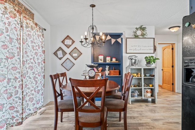 dining area with a notable chandelier and light wood-type flooring