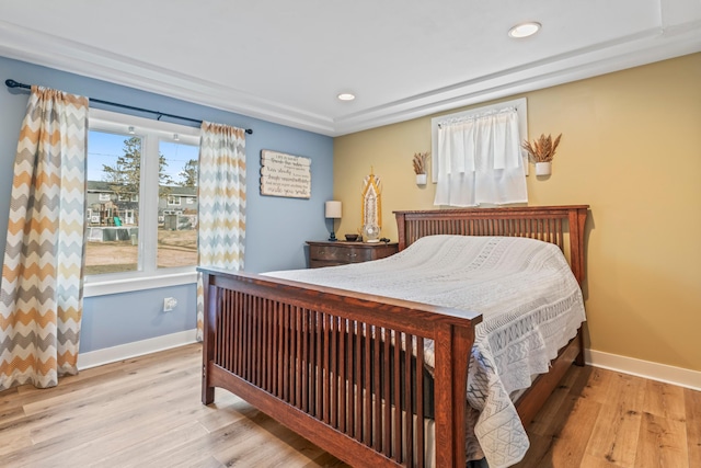 bedroom with multiple windows and light hardwood / wood-style floors