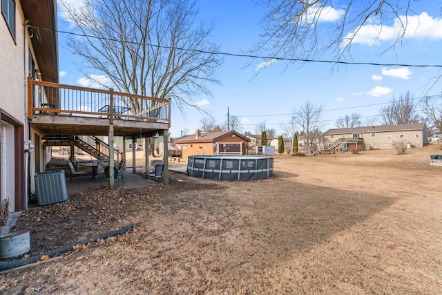 view of yard featuring a swimming pool side deck and cooling unit