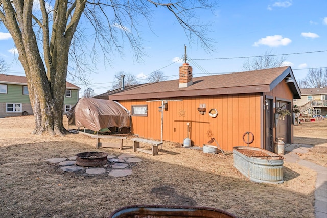 exterior space featuring an outdoor fire pit