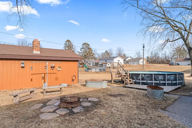 view of yard featuring an outdoor fire pit