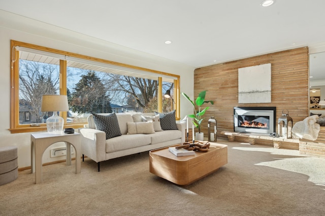 carpeted living room featuring wood walls and a wealth of natural light