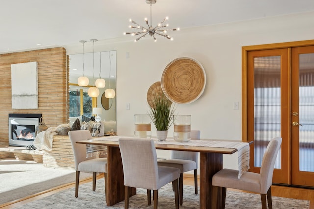 dining room featuring hardwood / wood-style floors, a chandelier, and french doors