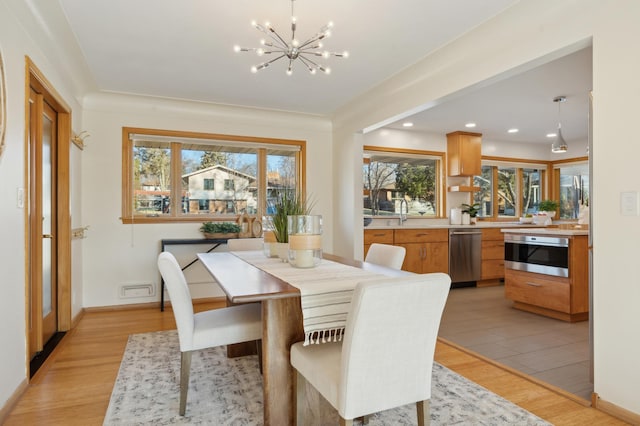 dining room featuring a chandelier and light hardwood / wood-style flooring