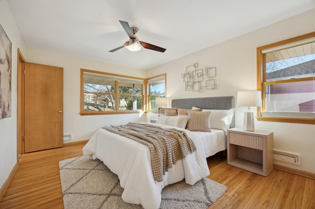 bedroom with light hardwood / wood-style flooring and ceiling fan