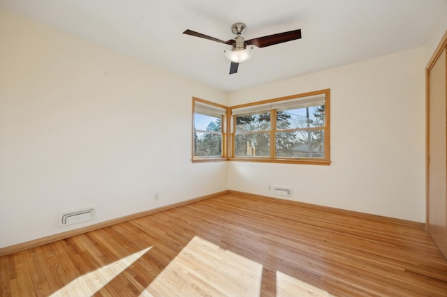 empty room featuring ceiling fan and light hardwood / wood-style floors