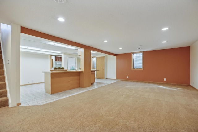 unfurnished living room with light colored carpet