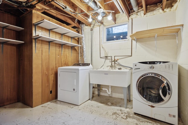 clothes washing area with sink and washer and dryer