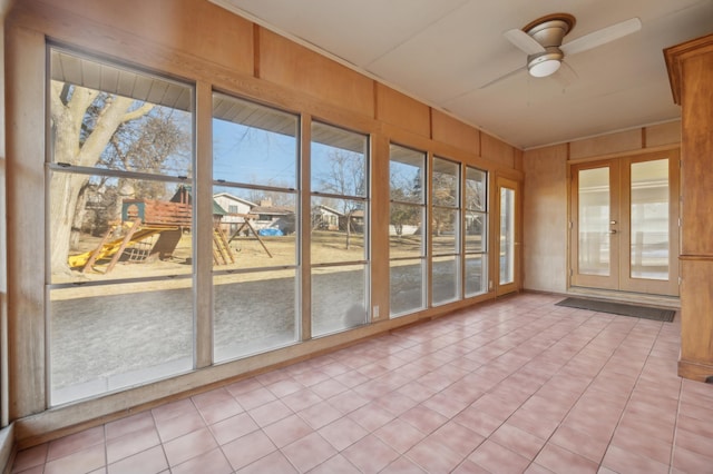 unfurnished sunroom with ceiling fan and french doors