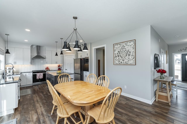 dining space with dark hardwood / wood-style floors and sink