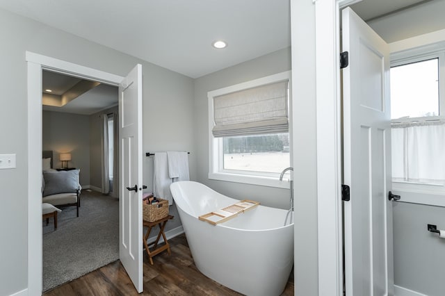 bathroom featuring a bath and hardwood / wood-style flooring