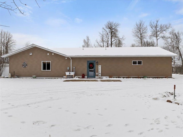 view of snow covered back of property