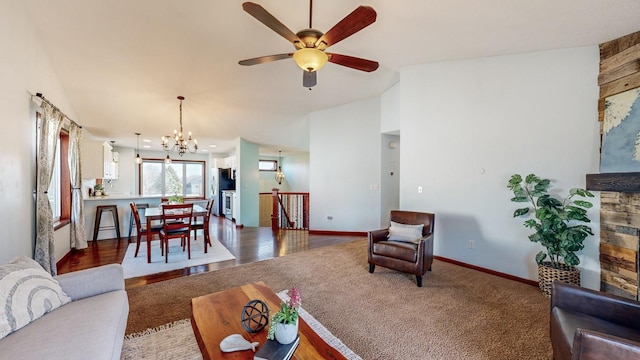 living room featuring carpet floors and ceiling fan with notable chandelier