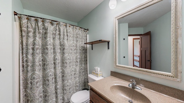 bathroom with vanity, a textured ceiling, and toilet