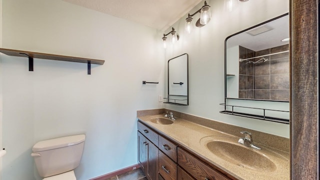 bathroom featuring tile patterned flooring, vanity, and toilet