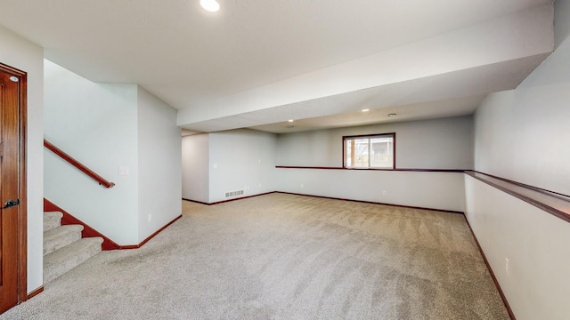 basement featuring light carpet