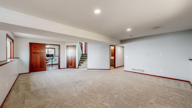 unfurnished room featuring light carpet