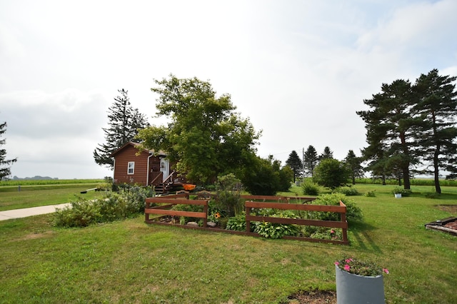 exterior space featuring a rural view and a lawn