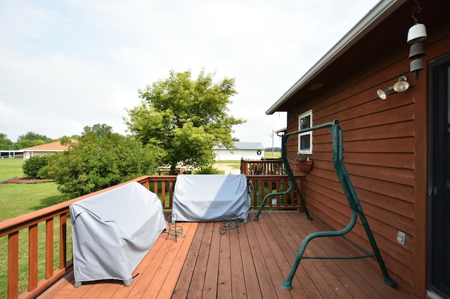 deck with area for grilling and a yard