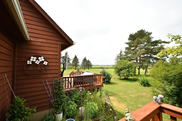 view of yard featuring a rural view and a wooden deck