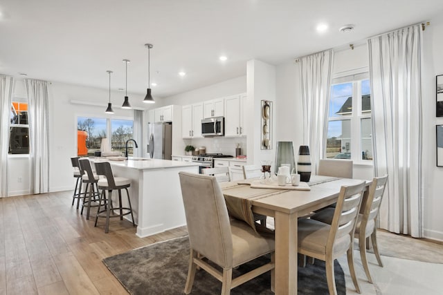 dining room with sink and light hardwood / wood-style floors